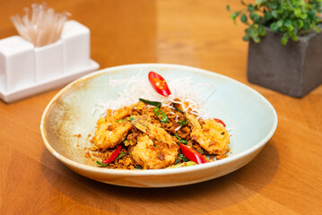 Fried tiger prawns with chili, onion and herbs, Asian lunch.