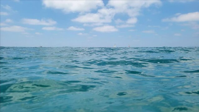 Video filming of the mediterranean sea from a low angle, from the level of the water surface, a view of the horizon