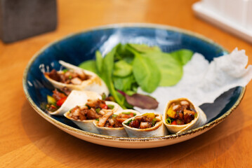 Rolls with duck and vegetables in a tortilla, Peking duck appetizer.