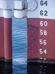 Draft marks on a ship with red and white paint.