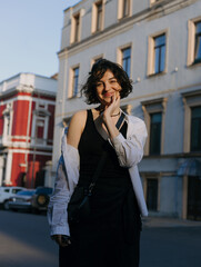 Beautiful and cute girl walking around the city in the setting sun