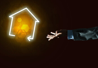 Conceptual image with hand pointing at house or main page icon on dark background