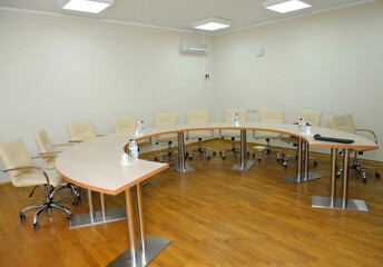 Conference room with a table, chairs and bottles with water put
