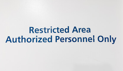 A sign depicting 'Authorized Personnel Only,' symbolizing restricted access, security, and the...