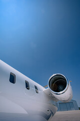 Business Jet Turbofan Engine and Windows with Hangar in the Background.