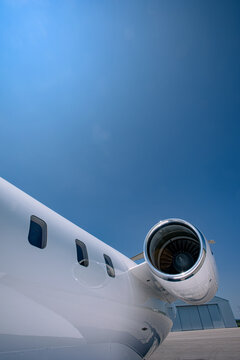 Business Jet Turbofan Engine and Windows with Hangar in the Background.