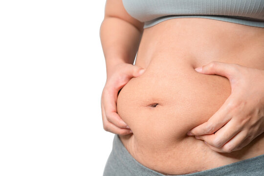 Chubby woman hand holding belly fat, Woman diet lifestyle concept,  Isolate on white background.