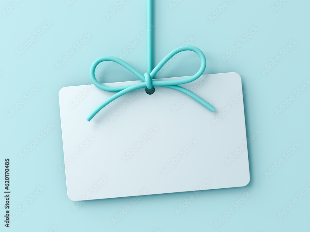 Poster blank gift card or hanging white note with blue cyan rope bow isolated on blue pastel color wall bac