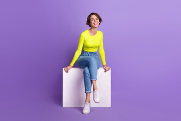 Full length photo of gorgeous satisfied glad person sitting podium have good mood isolated on violet color background