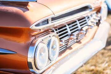 Detail of an old american car with headlight and radiator
