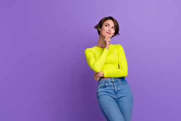Portrait of pretty positive lady hand touch chin look empty space contemplate isolated on purple color background