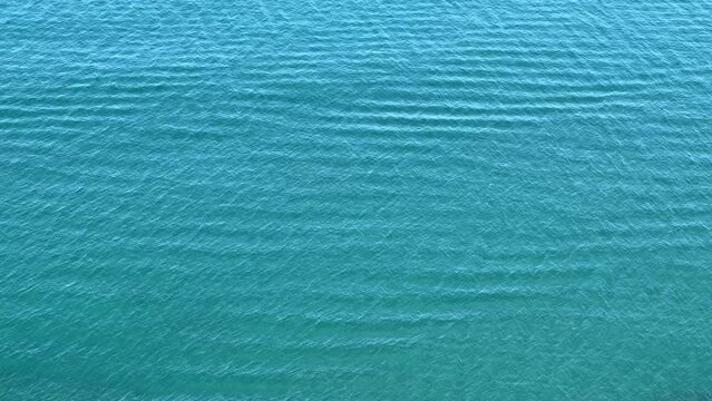 Blue water surface flowing ripples.