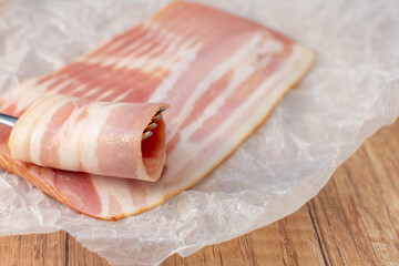 Raw bacon on parchment paper