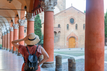 Young elegant  tourist with hat looking at Piazza santo Stefano, Bologna - Italy © xamnex