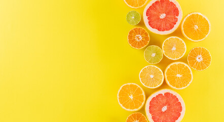 Summer composition made from oranges, lemon or lime on pastel yellow background. Fruit minimal concept.
