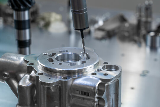 Measurement and control of the dimensions of a metal engine block part using a probe stylus ball tip of multi-axis coordinate measuring machine.