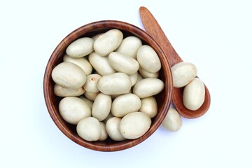 Jackfruit seeds in a wooden bowl on white background top view 