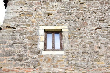 Part of the wall of an ancient castle with a window