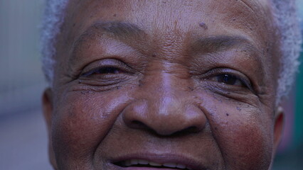 Macro close-up of a joyful black Brazilian woman eyes smiling at camera