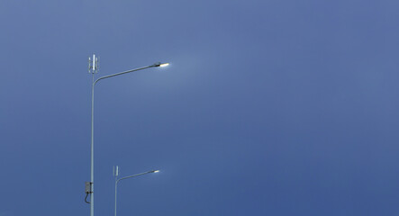 Small wind turbine on street light pole with blue sky background, Lamp post with solar and wind turbine alternative energy for better world concept