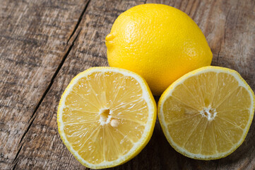 Fototapeta na wymiar Ripe juicy lemons. Citrus fruits on the wooden background