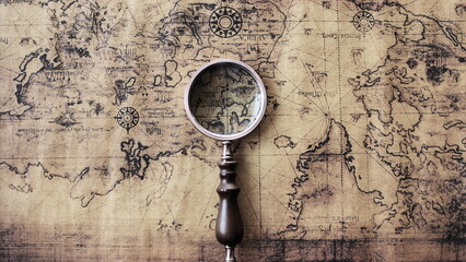 Magnifying glass and an ancient old map,Old map with an magnifying glass,Top view of glasses and world map