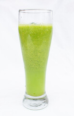 vegetable juice, apple, vegetables, green color, tall transparent glass, white background, natural, delicious taste.