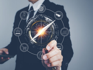 Businessman using a business compass magnifying glass Guide market direction, investment, finance,...