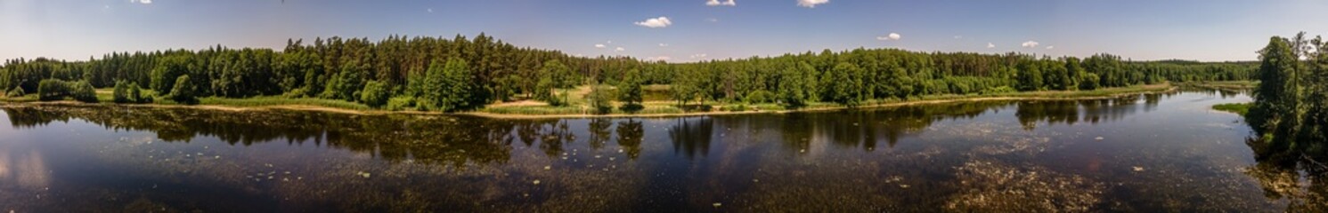 Fototapeta na wymiar Aerial panorama of the lake in the forest in Podlasie ,Poland on a sunny,spring day.