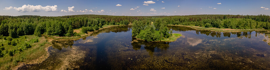 Naklejka na ściany i meble Aerial panorama of the lake in the forest in Podlasie ,Poland on a sunny,spring day.