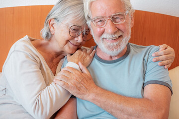 Love lives forever! Senior couple portrait hugging cuddling at home bedroom. Handsome old man and...