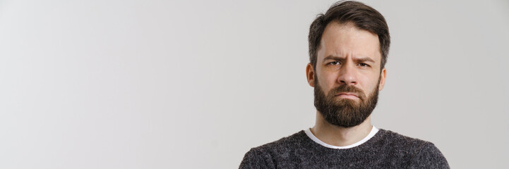 Fototapeta premium White mid man with beard frowning and looking at camera
