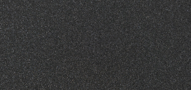 Background filled with black particles.