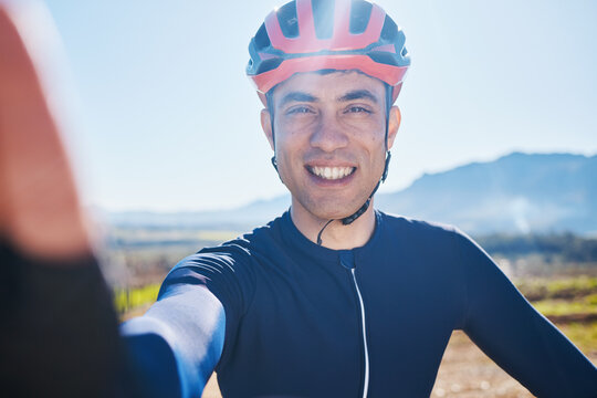 Selfie, portrait or happy man cycling by mountains on countryside in Switzerland for fitness. Face, smile or sports athlete biker with photo or profile picture in training, workout or exercise trip
