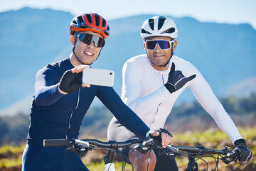 Fitness, bike and selfie with friends in nature for cycling, taking a break from a cardio or endurance workout. Exercise, mountain and man cyclist team taking a picture together while sports training