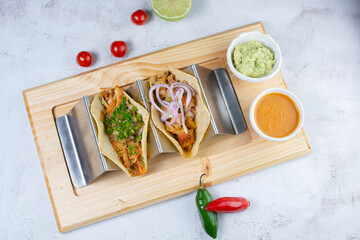 Traditional Mexican tacos, pork, cheese, pico de gallo, onion, served with guacamole and hot sauce