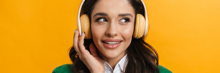 Happy young casual white woman listening to music