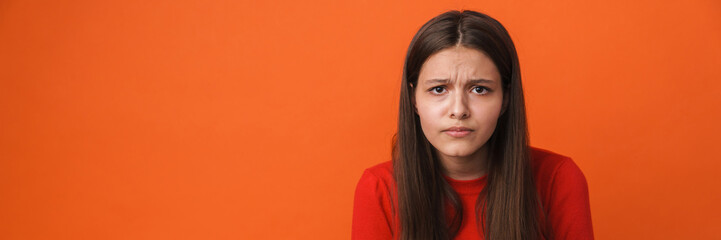 Young white brunette woman frowning and looking at camera