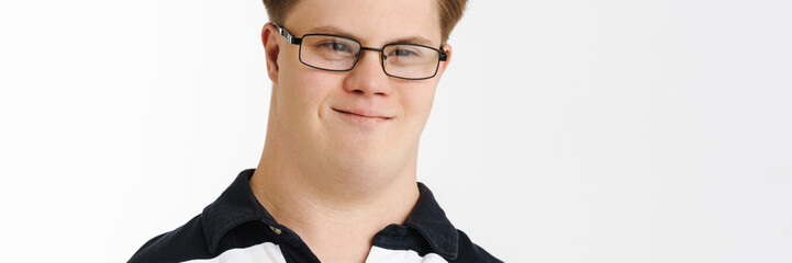 Young man with down syndrome smiling and looking at camera