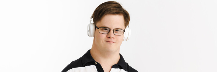 Young man with down syndrome using headphones while listening music