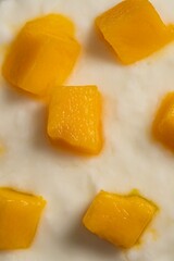 Delicious glass of cold yogurt mousse with mango.