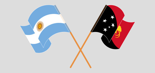 Crossed and waving flags of Argentina and Papua New Guinea