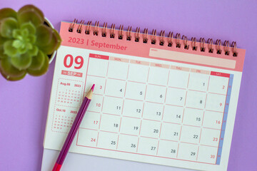Desktop calendar for September 2023 on a lilac background. - obrazy, fototapety, plakaty