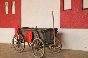 Fototapeta na wymiar alter Handwagen mit roten Schleifen dekoriert 