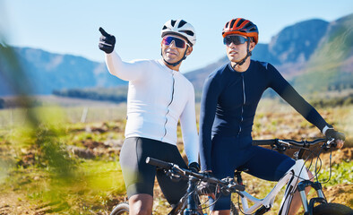 Exercise, bike and pointing with friends in nature for cycling, taking a break from a cardio or endurance workout. Fitness, mountain or countryside view with a man cyclist team training for sports