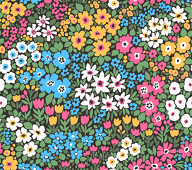 Beautiful floral pattern in small abstract flowers. Small colorful flowers. Black background. Ditsy print. Floral seamless background. Liberty template for fashion prints. Stock pattern.