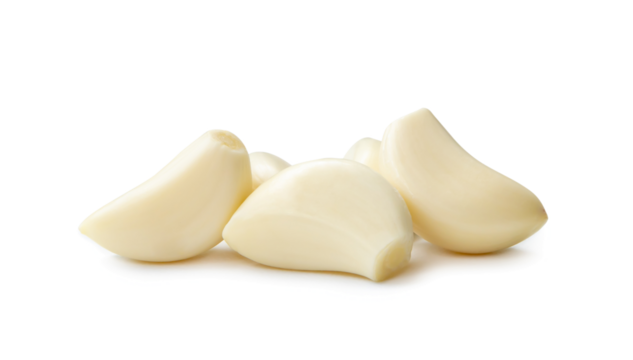 Peeled garlic cloves in stack isolated on white background with clipping path and shadow in png file format