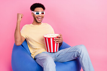 Photo of young guy fist up wear 3d goggles surprised celebrate new episode dc film eat snacks...