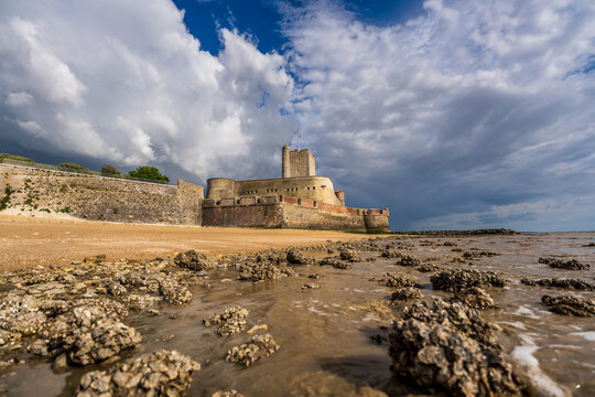 Fort Vauban de Fouras as seen from the Grande Plage beach during sunset with a storm coming in, Fouras, France