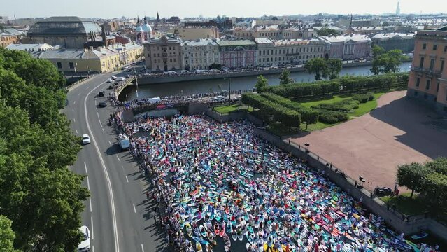 St. Petersburg, summer 2022: aerial view crowd of people on paddle boards in the city river, Fontanka SUP festival